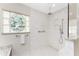 Bathroom featuring marble floors, granite countertops, stained glass window, and open shower with glass at 351 Eden Dr, Englewood, FL 34223