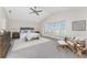 Main bedroom featuring bay windows, neutral walls and carpet, a ceiling fan, and sitting area at 351 Eden Dr, Englewood, FL 34223