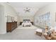 Spacious main bedroom with carpet, ceiling fan, light colored walls, bay window, and walk-in closet at 351 Eden Dr, Englewood, FL 34223