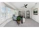 Bright home office with neutral walls, plush carpeting, and a large window with plantation shutters at 351 Eden Dr, Englewood, FL 34223