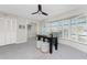 A carpeted office features a ceiling fan and a bay window providing natural light at 351 Eden Dr, Englewood, FL 34223