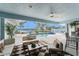 Outdoor patio with seating area, tile flooring, ceiling fan, and view of screened in pool and patio area at 351 Eden Dr, Englewood, FL 34223