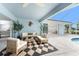 Charming patio featuring stylish furniture, black and white rug, and access to a screened pool at 351 Eden Dr, Englewood, FL 34223