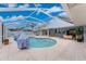 Stunning screened pool with an integrated spa, featuring outdoor seating and access to the home's interior at 351 Eden Dr, Englewood, FL 34223