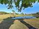 Scenic view of a pond with golf course and building in the background at 429 Cerromar Ln # 352, Venice, FL 34293