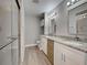 Modern bathroom with double sinks, granite countertops, and a glass-enclosed shower at 429 Cerromar Ln # 352, Venice, FL 34293