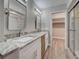 Renovated bathroom with double sinks, granite countertops, glass shower and walk-in closet at 429 Cerromar Ln # 352, Venice, FL 34293