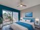Bright bedroom design featuring wood floors, sliding glass door, and stylish blue decor at 429 Cerromar Ln # 352, Venice, FL 34293