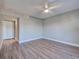 Simple bedroom featuring light wood floors, neutral walls, and a doorway leading to another room at 429 Cerromar Ln # 352, Venice, FL 34293