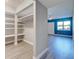 Walk-in closet features custom shelves, hanging rods, and modern flooring at 429 Cerromar Ln # 352, Venice, FL 34293