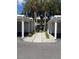 Condo exterior view showcasing palm trees, updated landscaping and assigned covered parking at 429 Cerromar Ln # 352, Venice, FL 34293