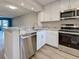 Kitchen showcasing white cabinets, stainless steel appliances, and granite counters at 429 Cerromar Ln # 352, Venice, FL 34293