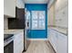 Well-lit kitchen showcases white cabinets, granite countertops, stainless steel refrigerator, and a pop of color with its blue accent wall at 429 Cerromar Ln # 352, Venice, FL 34293