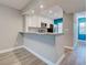 Open-concept kitchen featuring a breakfast bar, white cabinets, stainless steel appliances, and granite countertops throughout at 429 Cerromar Ln # 352, Venice, FL 34293