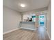Spacious living room with light wood floors, open access to the kitchen, and a bright window at 429 Cerromar Ln # 352, Venice, FL 34293