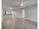 Open concept living room with fan, breakfast bar, and view of dining space and kitchen at 429 Cerromar Ln # 352, Venice, FL 34293