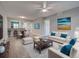 Living room featuring bright white furniture with teal accents and wall art at 429 Cerromar Ln # 352, Venice, FL 34293