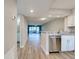 Living room with stainless steel dishwasher, granite counters, and wood look floors at 429 Cerromar Ln # 352, Venice, FL 34293