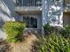 View of a patio with sliding glass doors and landscaped yard including a small pebble rock area at 429 Cerromar Ln # 352, Venice, FL 34293