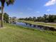 Picturesque pond surrounded by lush greenery and serene walking path at 432 Sunset Lake Blvd # 205, Venice, FL 34292