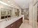 Modern bathroom features double sinks, a spacious shower, and ample counter space at 432 Sunset Lake Blvd # 205, Venice, FL 34292