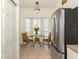 Cozy breakfast nook with a charming table set, bathed in natural light from the nearby bay window at 432 Sunset Lake Blvd # 205, Venice, FL 34292