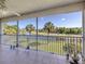 Relaxing screened lanai boasting serene water views and tropical landscaping at 432 Sunset Lake Blvd # 205, Venice, FL 34292