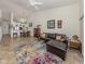 Inviting living room with tile flooring and a comfortable leather sectional sofa at 432 Sunset Lake Blvd # 205, Venice, FL 34292