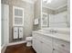 Bathroom featuring a white vanity with carrara marble countertops and modern fixtures at 48 Grande Fairway, Englewood, FL 34223