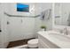 Bathroom with new shower, white tiled walls with decorative accent tile, vanity and updated fixtures at 48 Grande Fairway, Englewood, FL 34223
