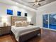 Serene bedroom features a plush bed, neutral decor, and a sliding door that provides access to the outdoor area at 48 Grande Fairway, Englewood, FL 34223