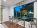 Entertainers game room offering counter seating and a wall of windows looking out onto the lanai at 48 Grande Fairway, Englewood, FL 34223