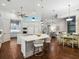 Contemporary open-plan kitchen featuring an eat-in island with barstools, modern appliances, and wood flooring at 48 Grande Fairway, Englewood, FL 34223