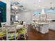 Open-concept kitchen and breakfast nook features a large island, white cabinetry, and modern lighting at 48 Grande Fairway, Englewood, FL 34223