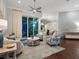 Elegant living room with a ceiling fan, modern decor, and sliding glass doors to the patio at 48 Grande Fairway, Englewood, FL 34223
