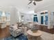 Spacious living room features a modern design, wood floors, and a view of the kitchen and dining areas at 48 Grande Fairway, Englewood, FL 34223