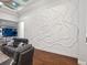 Stylish living room showcasing a unique decorative wall feature and comfortable seating arrangement at 48 Grande Fairway, Englewood, FL 34223