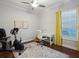 Office/flex room with a ceiling fan, desk, Peloton-style exercise bike, and shuttered windows at 48 Grande Fairway, Englewood, FL 34223