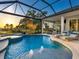 Beautiful swimming pool with fountain features, a jacuzzi, and plenty of space for lounging and entertaining at 48 Grande Fairway, Englewood, FL 34223