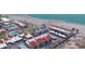 Aerial view showcasing beachfront condo buildings with a pool, parking, and beach access at 500 Park S Blvd # 62, Venice, FL 34285