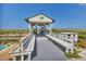 Beach access point with covered entrance and benches for relaxing and taking in the scenery at 500 Park S Blvd # 62, Venice, FL 34285