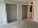 Bedroom with two walk-in closets, freshly painted walls and exposed concrete floors at 500 Park S Blvd # 62, Venice, FL 34285