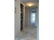 Hallway leading to a bright outdoor view, with a utility closet and access to other rooms at 500 Park S Blvd # 62, Venice, FL 34285