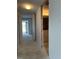 Hallway leading to bright spaces, offering a sense of openness and transition between rooms at 500 Park S Blvd # 62, Venice, FL 34285