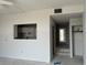 Open-concept living room with a pass-through to kitchen, leading to a hallway and a bright doorway at 500 Park S Blvd # 62, Venice, FL 34285