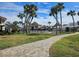 The community pool is surrounded by lush landscaping and palm trees, creating a relaxing oasis at 500 Park S Blvd # 62, Venice, FL 34285