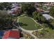 Aerial view of the community putting green with manicured landscaping and mature trees at 500 Park S Blvd # 62, Venice, FL 34285