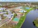 Community amenities from above: pool, tennis, shuffleboard, clubhouse, and picturesque lake views at 500 Wekiva River Ct # 129, Englewood, FL 34223
