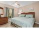 Cozy bedroom with soft decor, a window view, and wood-look floors at 500 Wekiva River Ct # 129, Englewood, FL 34223