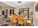 Formal dining room with wood table set for dinner with view to screened lanai at 500 Wekiva River Ct # 129, Englewood, FL 34223